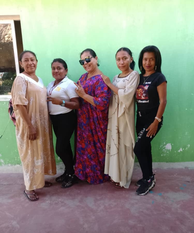 Frauen-Gruppe vor einer grünen Wand mit einem Fenster auf der linken Seite bei einem Internationalen Frauentag-Event